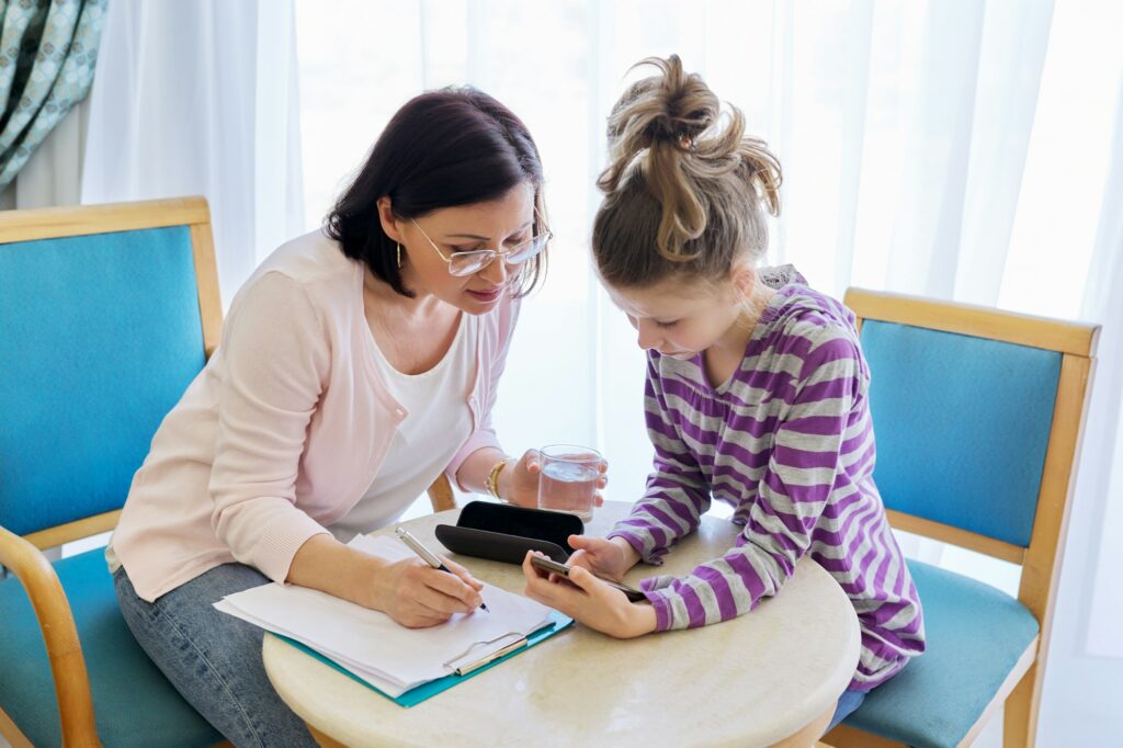 Preteen child girl at meeting with therapist in office